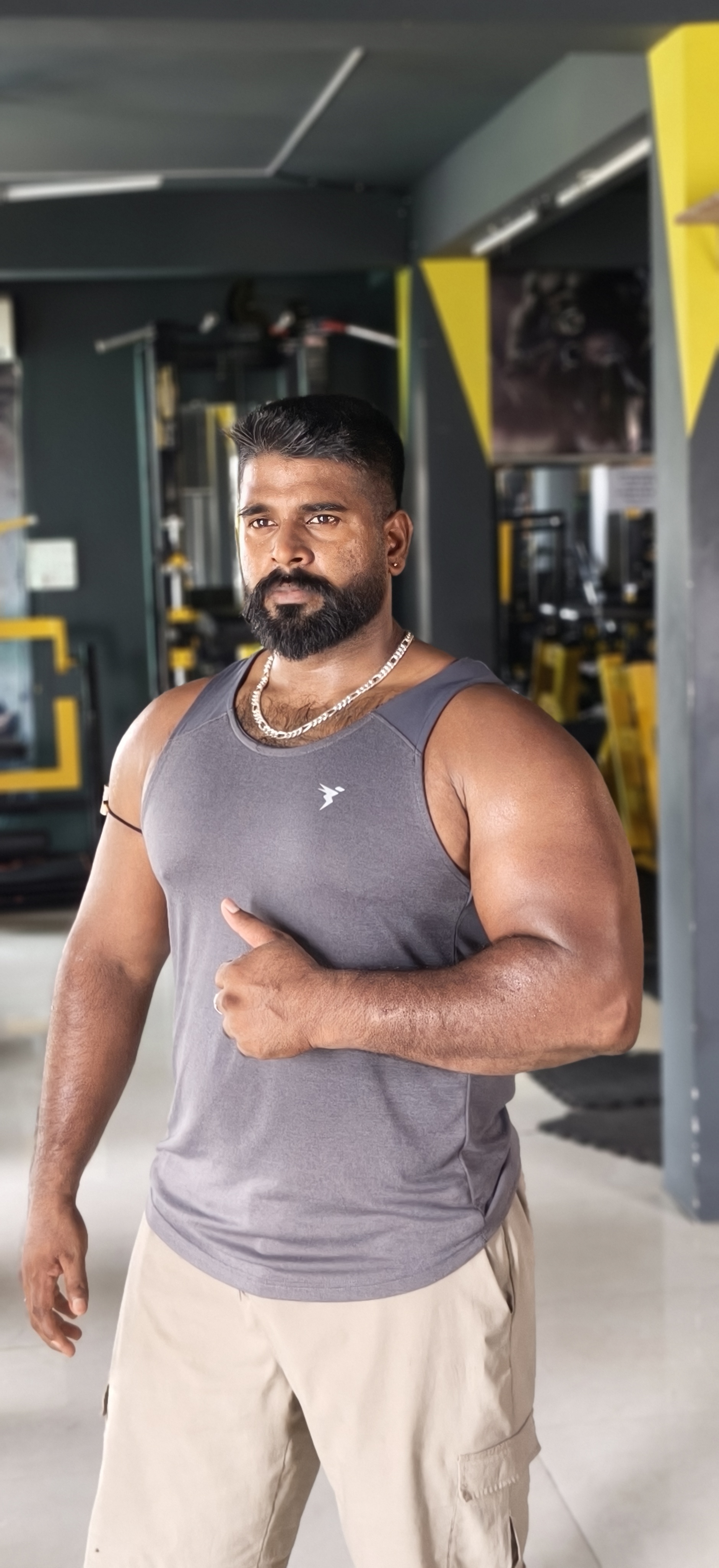 Personal trainer coaching a member through a dumbbell set